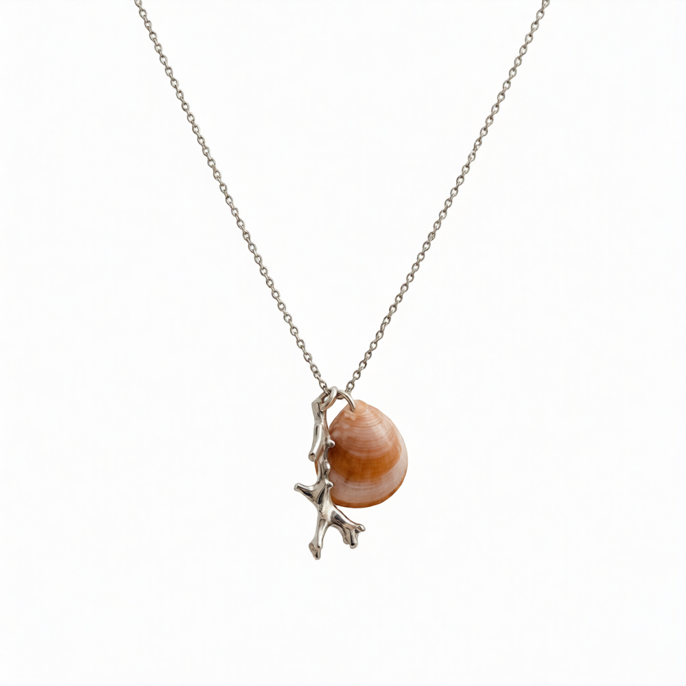 Silver coral pendant by Chorthip featuring a detailed, handcrafted coral-shaped design on a sleek silver chain.