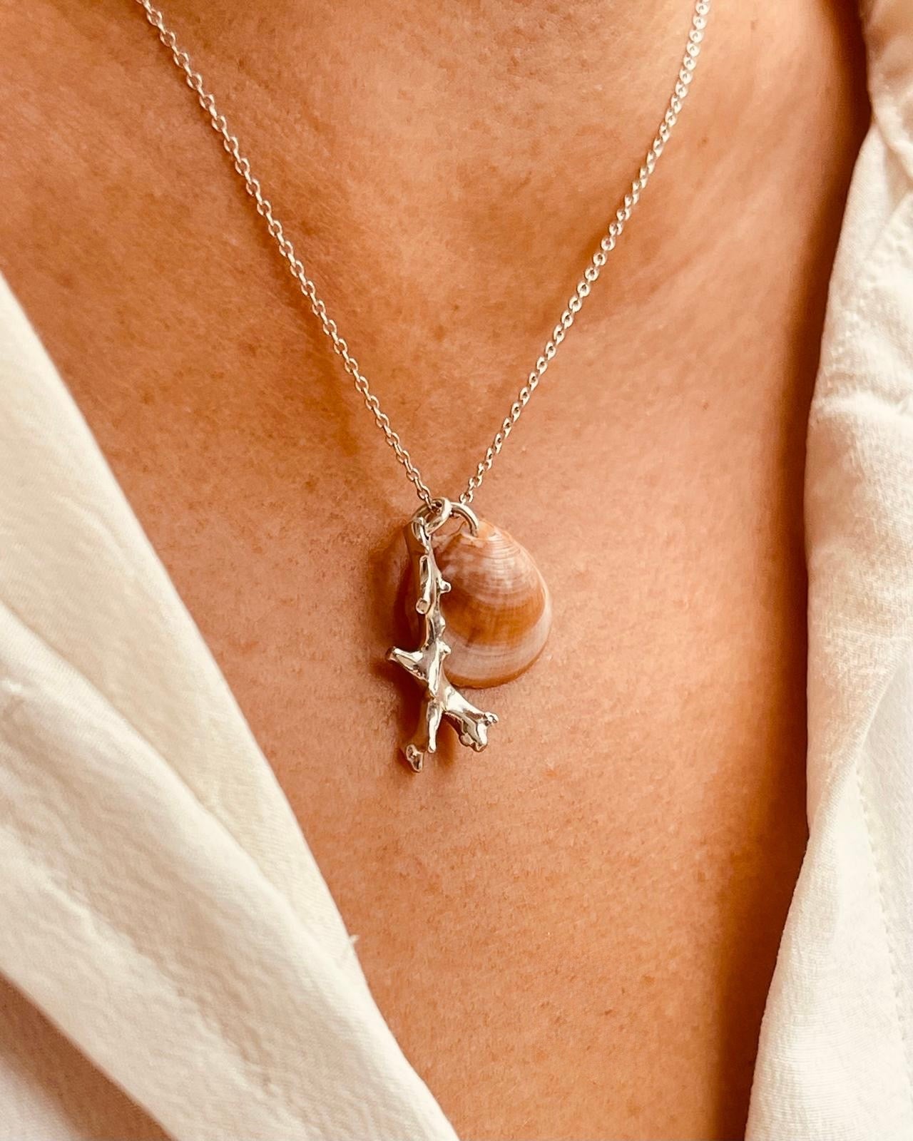 Silver coral pendant by Chorthip featuring a detailed coral design on polished silver chain.