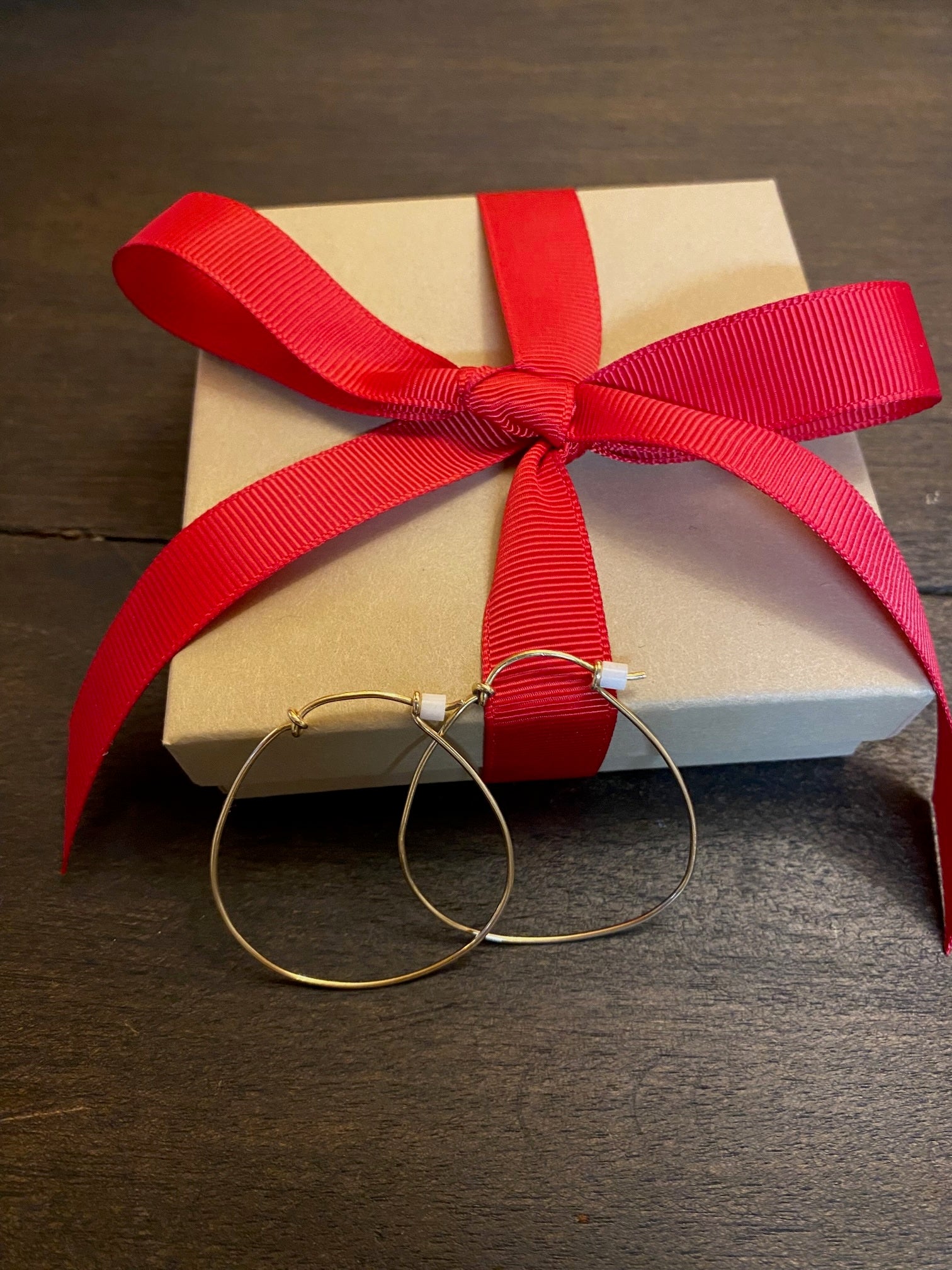 Gold horseshoe hoop earrings by Chorthip featuring sleek, circular design with a polished finish and secure clasp.