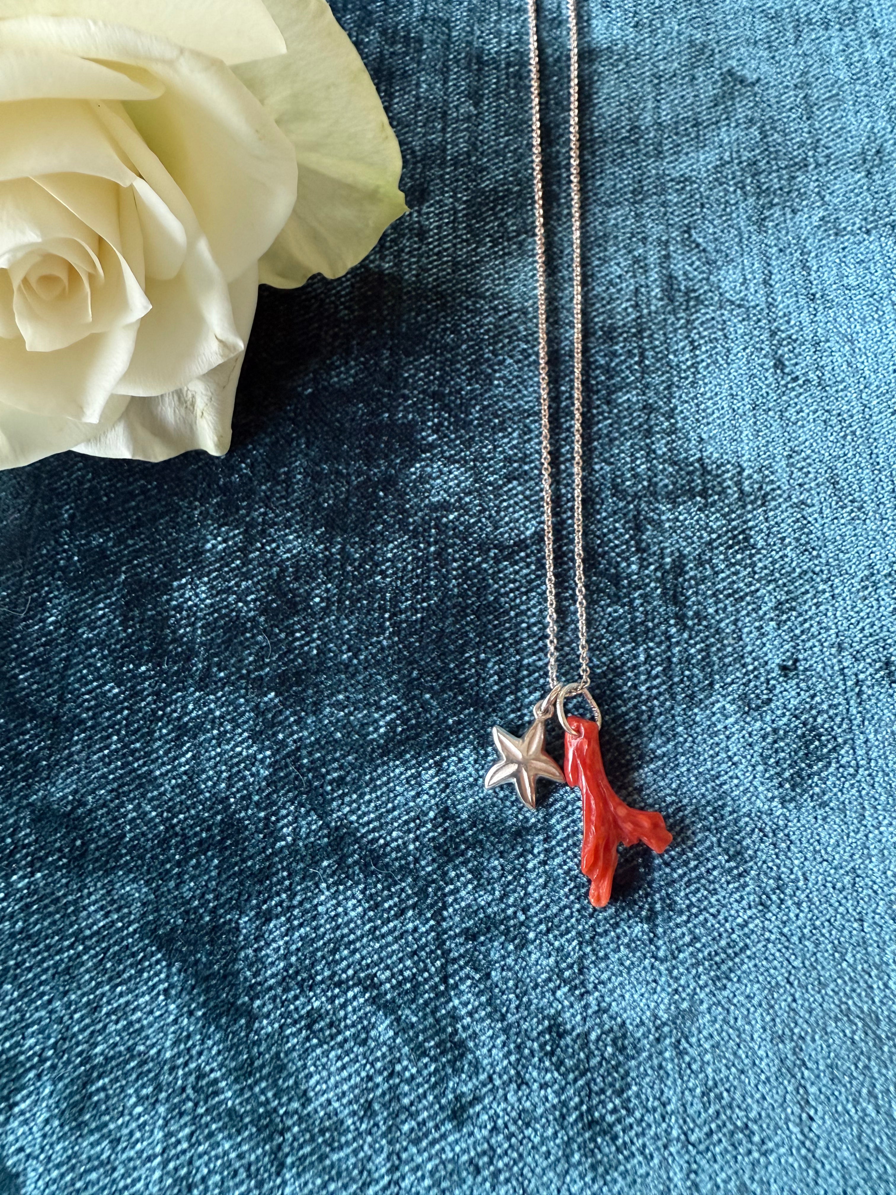 Silver starfish charm pendant by Chorthip featuring a detailed starfish design on a sleek silver pendant.