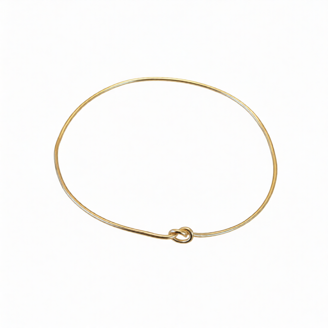 Chorthip single knot bangle bracelet with a sleek, minimalist design, featuring a smooth metal finish and elegant knot detail.