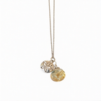 Silver sand dollar pendant with a citrine tear drop stone, crafted by Chorthip, showcasing intricate ocean-inspired design.