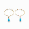 Chorthip lotus knot hoop earrings with dangling Sleeping Beauty turquoise drop stones, elegant jewelry for pierced ears.