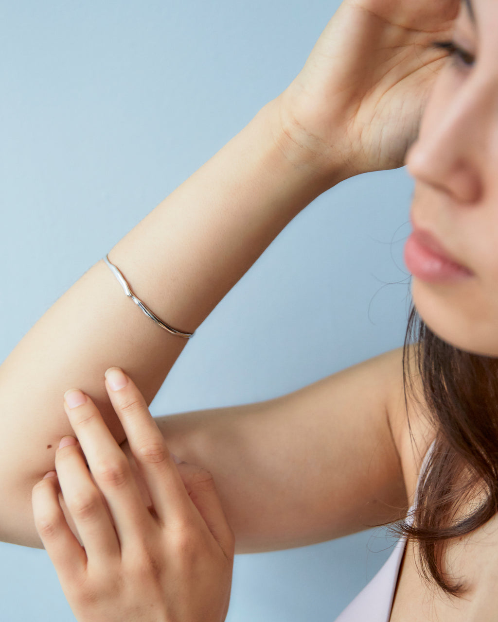 Chorthip Raindrop Bangle with sleek, polished design, featuring a smooth, rounded shape perfect for elegant wristwear.