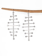 Chorthip Arisa Twilight mobile earrings featuring delicate hanging design with gemstone accents on a white background