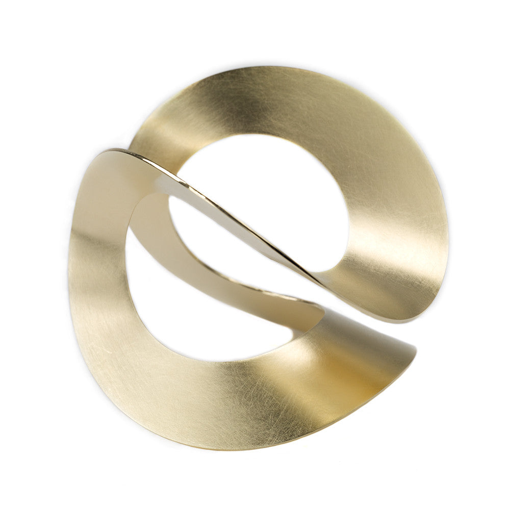 Chorthip Möbius Bangle featuring sleek, minimalist silver design with smooth curves and polished finish.