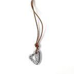 Chorthip stone heart pendant with a polished, natural stone heart shape hanging from a silver chain.