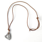 Silver stone heart pendant by Chorthip featuring a smooth, polished heart-shaped design with subtle carved details.