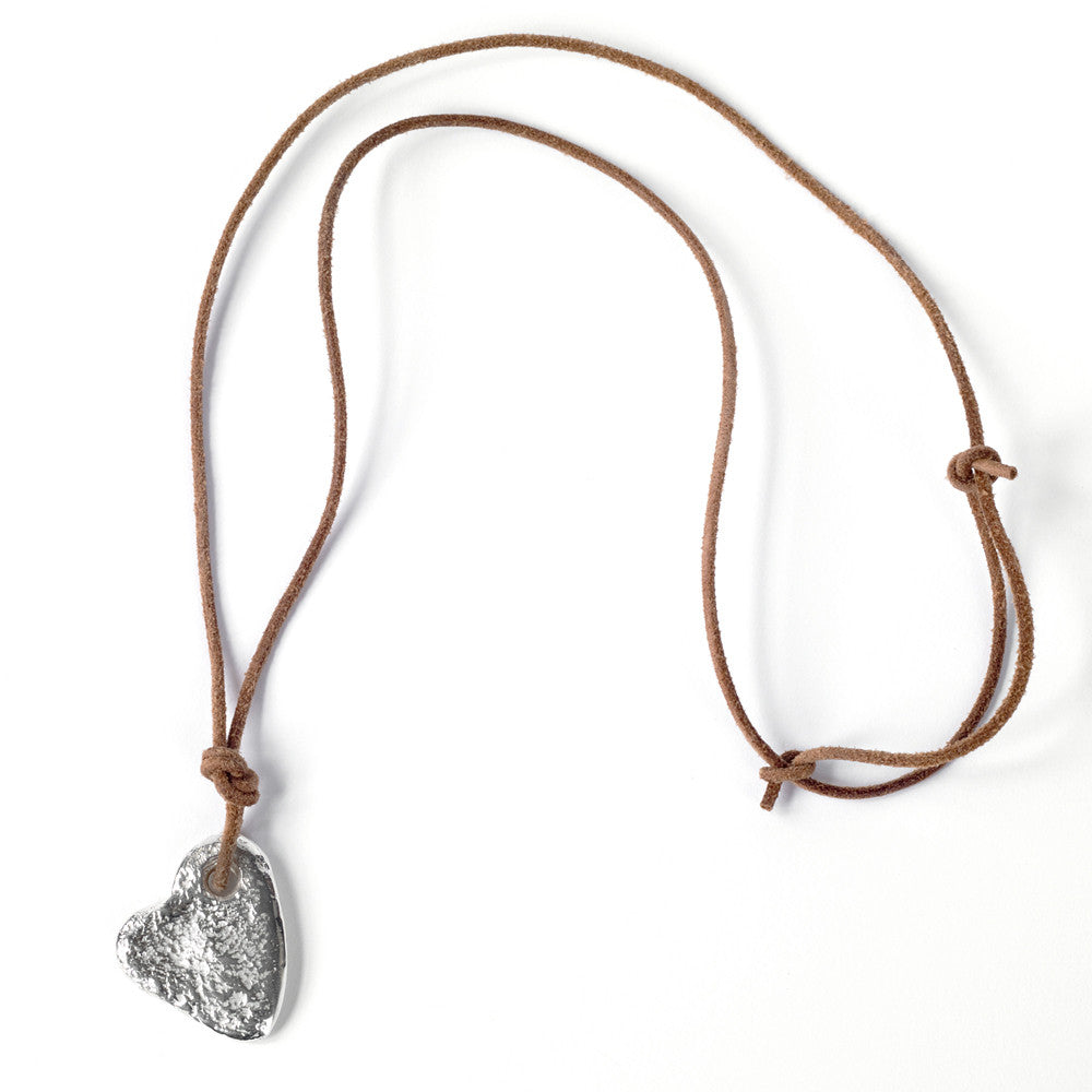 Silver stone heart pendant by Chorthip featuring a smooth, polished heart-shaped design with subtle carved details.