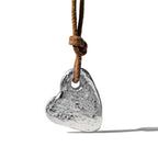 Stone heart pendant by Chorthip featuring a smooth, polished heart-shaped design with a delicate chain.