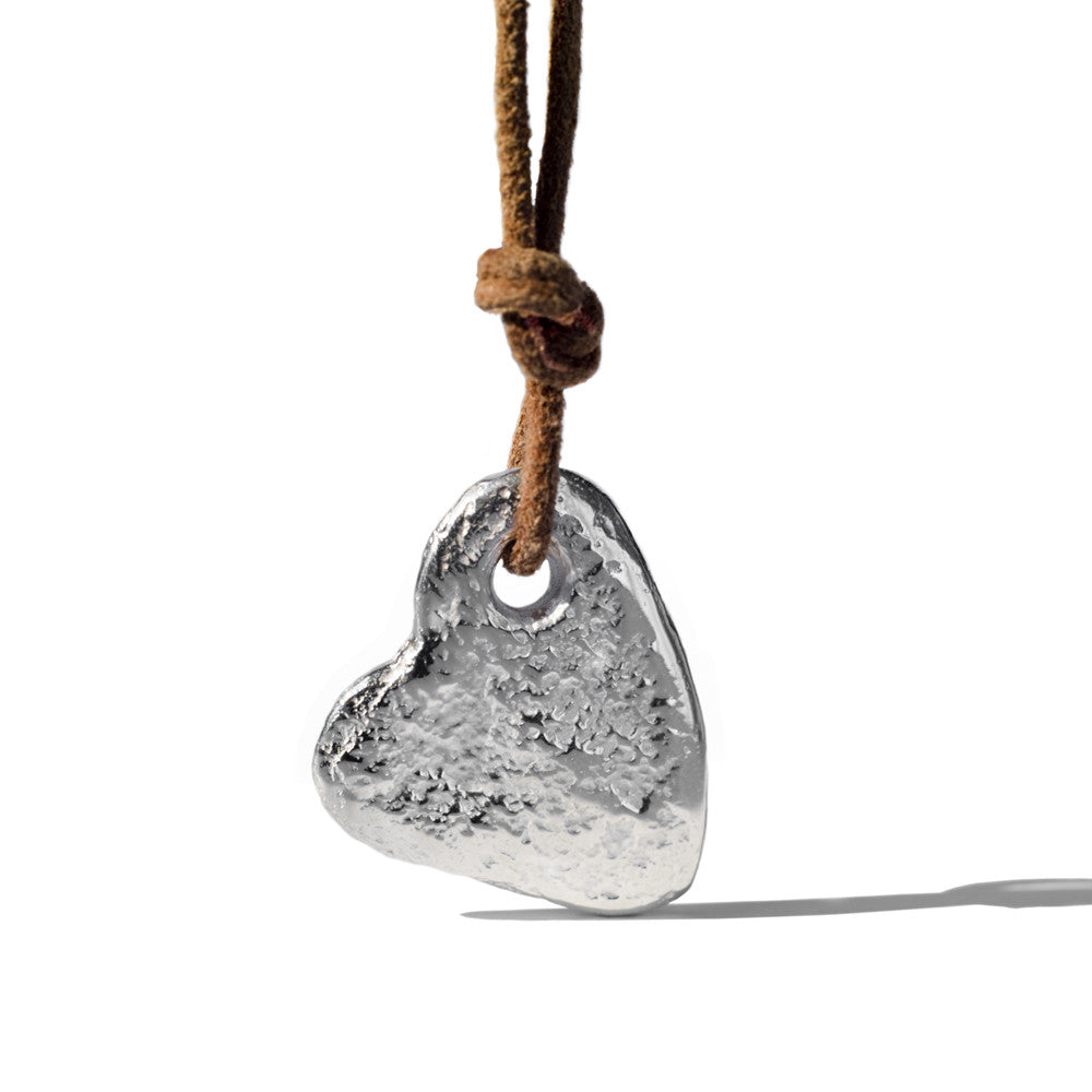 Stone heart pendant by Chorthip featuring a smooth, polished heart-shaped design with a delicate chain.