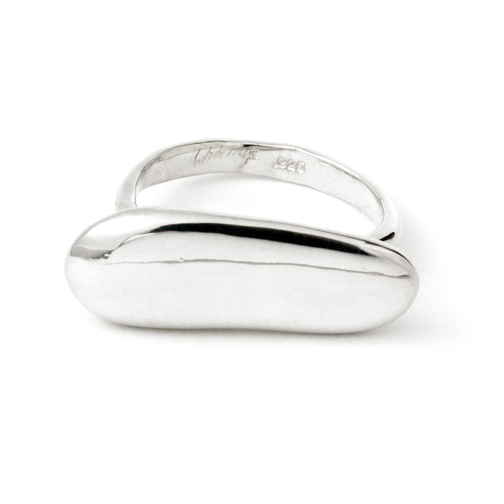 Elongated pebble-shaped ring by Chorthip featuring smooth stone design and a sleek band, shown on a neutral background.