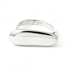 Elongated pebble-shaped ring by Chorthip featuring smooth stone design and a sleek band, shown on a neutral background.