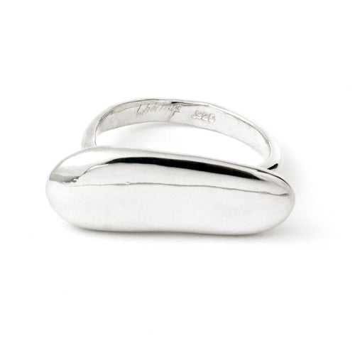 Elongated pebble-shaped ring by Chorthip featuring smooth stone design and a sleek band, shown on a neutral background.