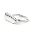 Silver elongated pebble ring by Chorthip featuring smooth, rounded stone-like design and a sleek, modern band style.