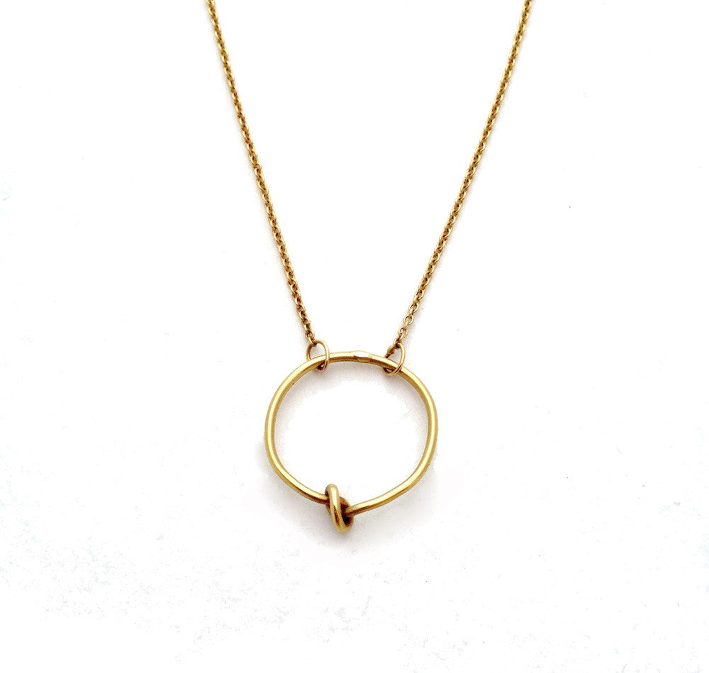 Chorthip Circle Knot Pendant necklace featuring a sleek, circular knot design in polished metal on a delicate chain