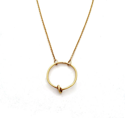 Chorthip Circle Knot Pendant necklace featuring a sleek, circular knot design in polished metal on a delicate chain