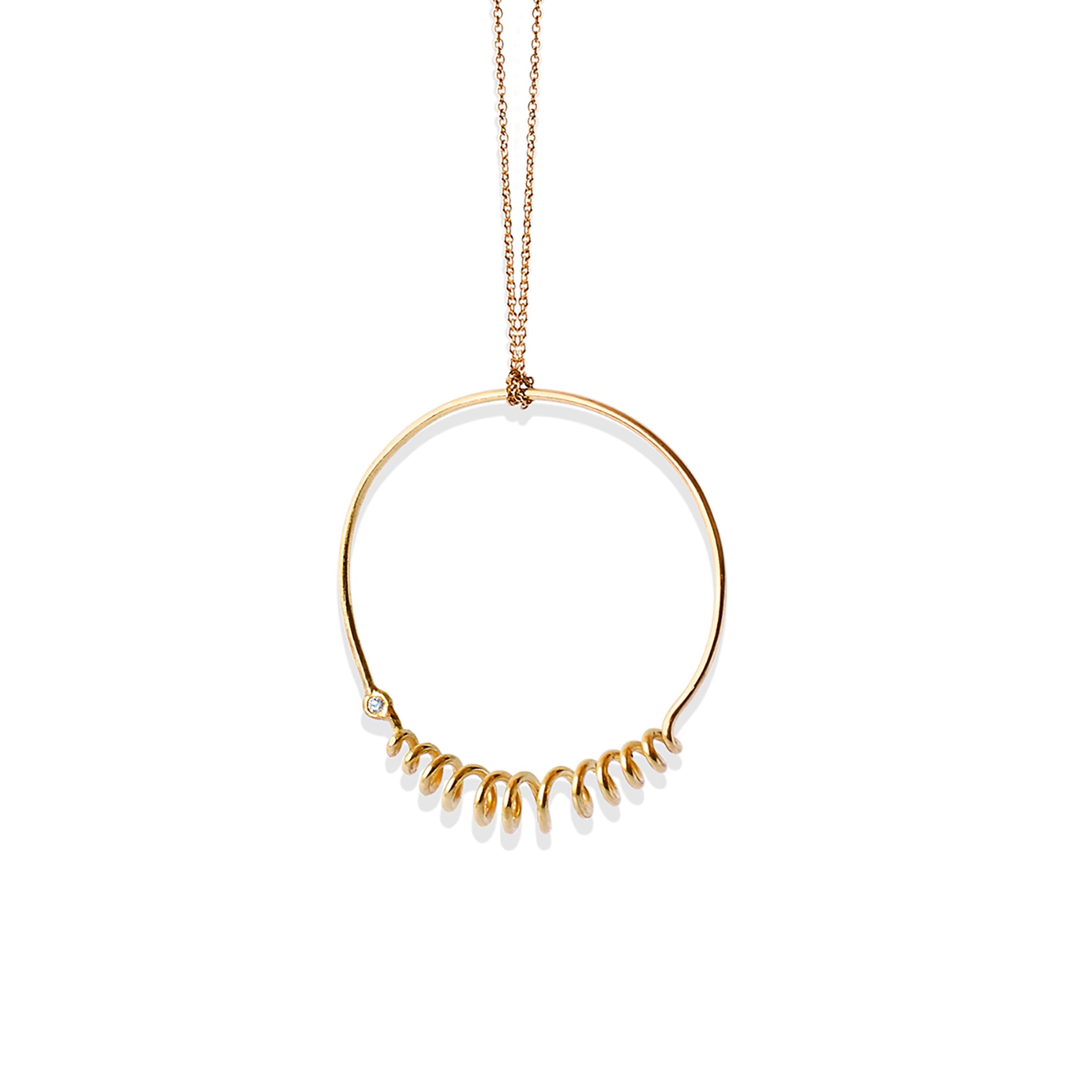 Closeup of Chorthip Helix Circle Pendant showing its spiral design and polished silver finish.