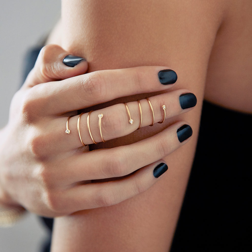 Close-up of Chorthip Helix Double Spiral Ring showing its intricate twisted silver design on a plain background