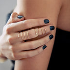 Close-up of Chorthip Helix Double Spiral Ring showing its intricate twisted silver design on a plain background