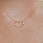 Chorthip Heart Knot Pendant featuring a polished silver heart-shaped knot design on a delicate chain.