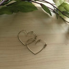 Chorthip Heart Hoop Earrings, stylish gold-toned earrings with heart-shaped hoops, suitable for everyday wear.