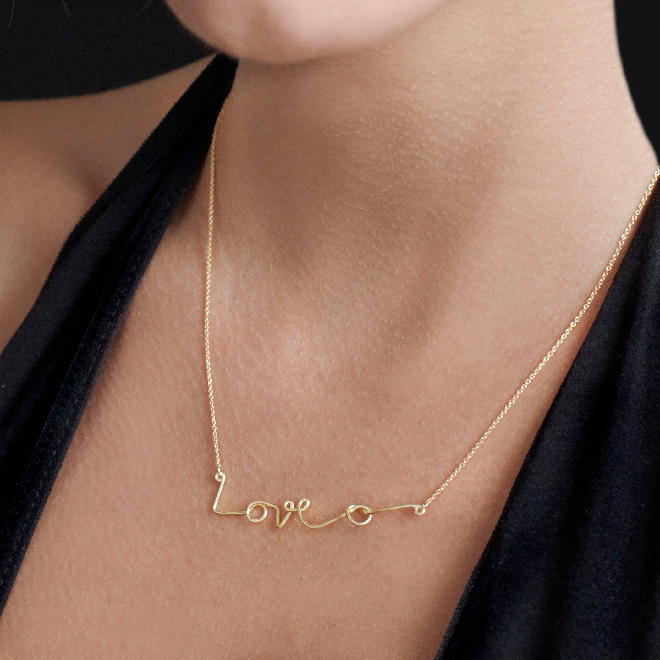 Chorthip Love Knot Necklace featuring a delicate intertwined heart-shaped pendant on a fine chain.
