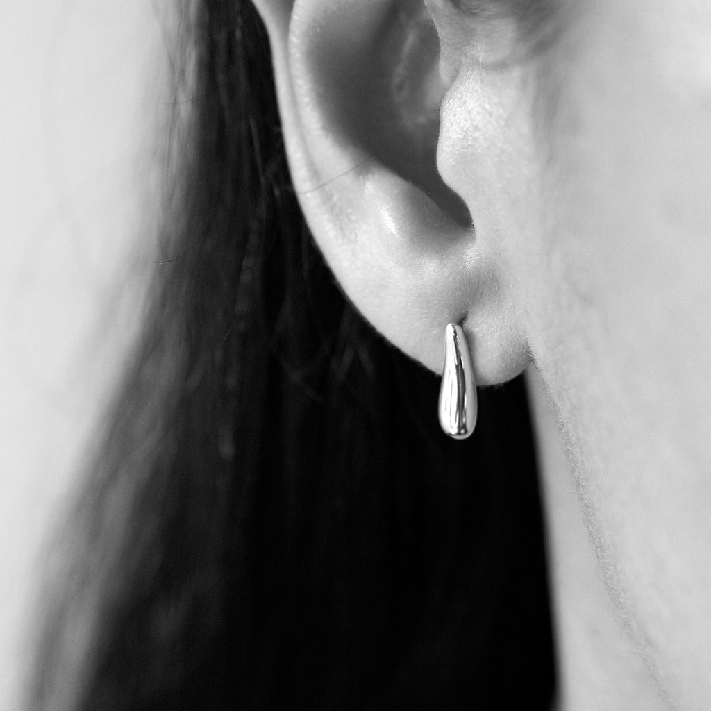 Small rain-shaped earrings by Chorthip, featuring delicate silver droplets with a polished finish.