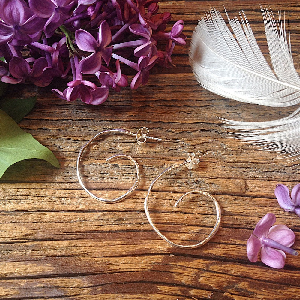 Chorthip Spiral Hoop Raindrop Earrings with sleek, dangling raindrop design and spiral hoop shape in shiny metal finish.