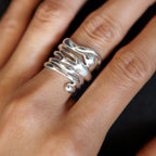 Chorthip Raindrop Ring featuring a sleek, silver band with a teardrop-shaped design, close-up of the elegant jewelry piece