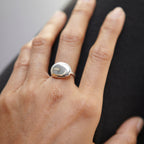 Round pebble stone ring by Chorthip featuring smooth, natural stone design set in a stylish ring band.