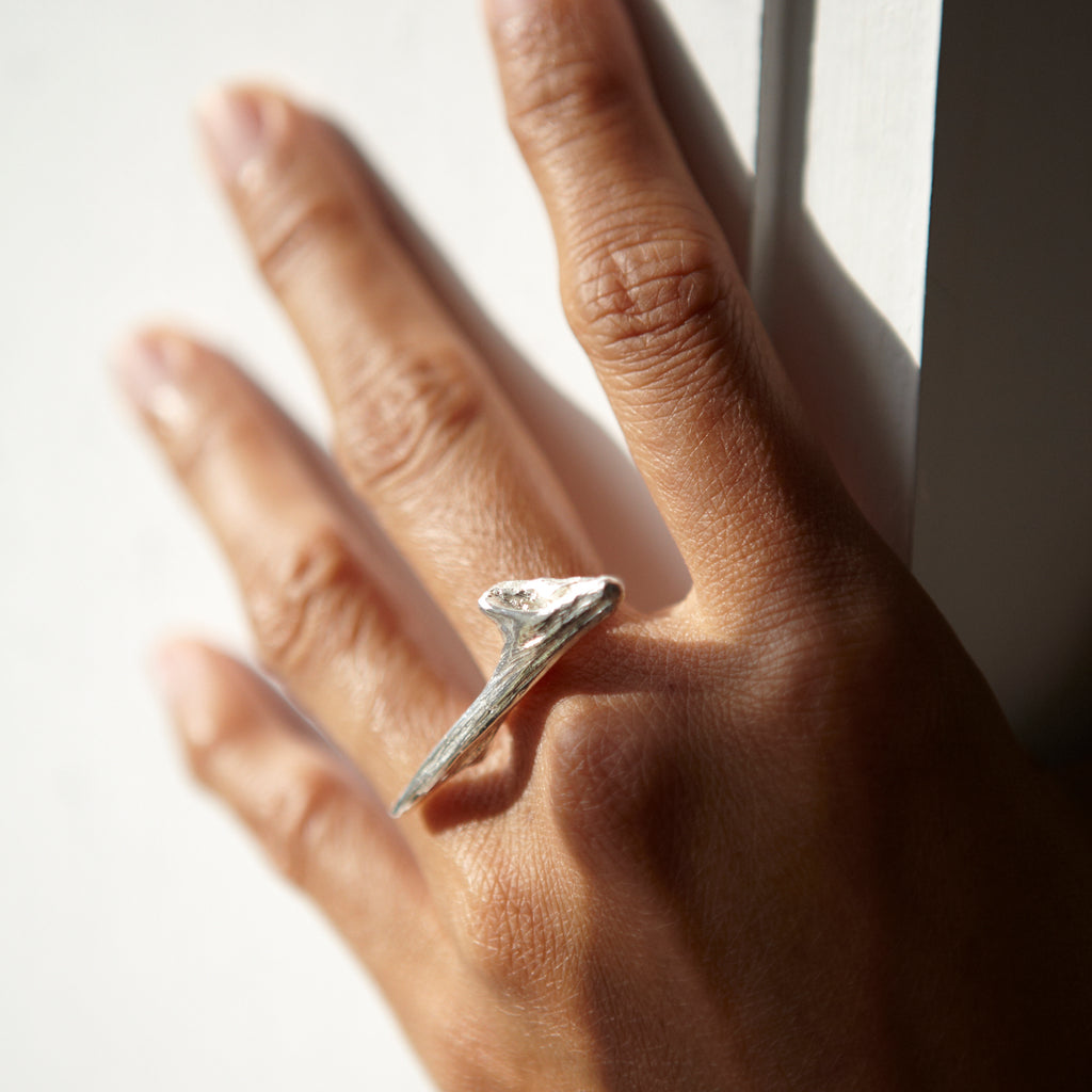 Close-up of a Chorthip Drift Wood Ring showcasing its natural wood grain and handcrafted design on a neutral background.