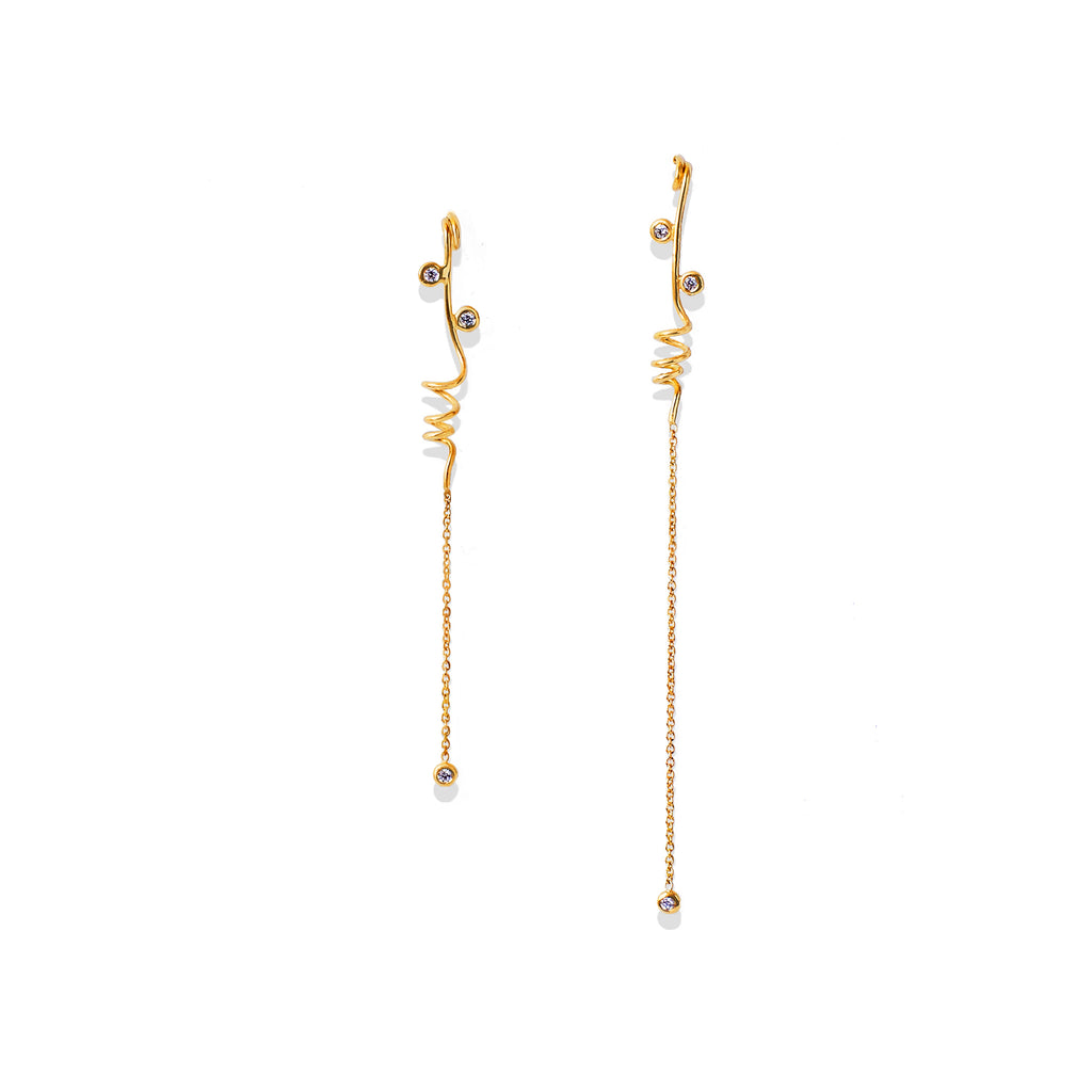 Chorthip Helix Spiral Drop Earrings with sleek, twisting silver design hanging from earlobes.
