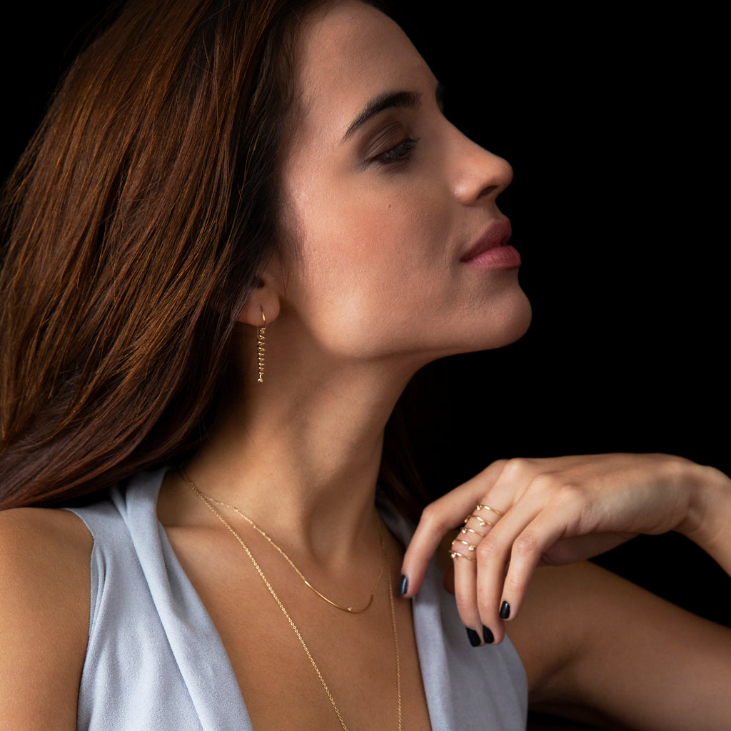 Chorthip Helix Spiral Earrings featuring sleek, twisted metal design with a polished finish, hanging gracefully from earlobes.
