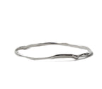 Silver Raindrop Bangle by Chorthip featuring a sleek, curved design with shiny raindrop-shaped accents on a smooth band.