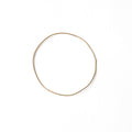 Single URS Gold Bangle by Chorthip featuring a smooth, polished gold wave design on a sleek jewelry bangle.